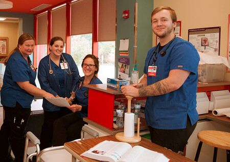Three women and one man at Concord Hospital in the regsitered apprenticeship program for medical assistants